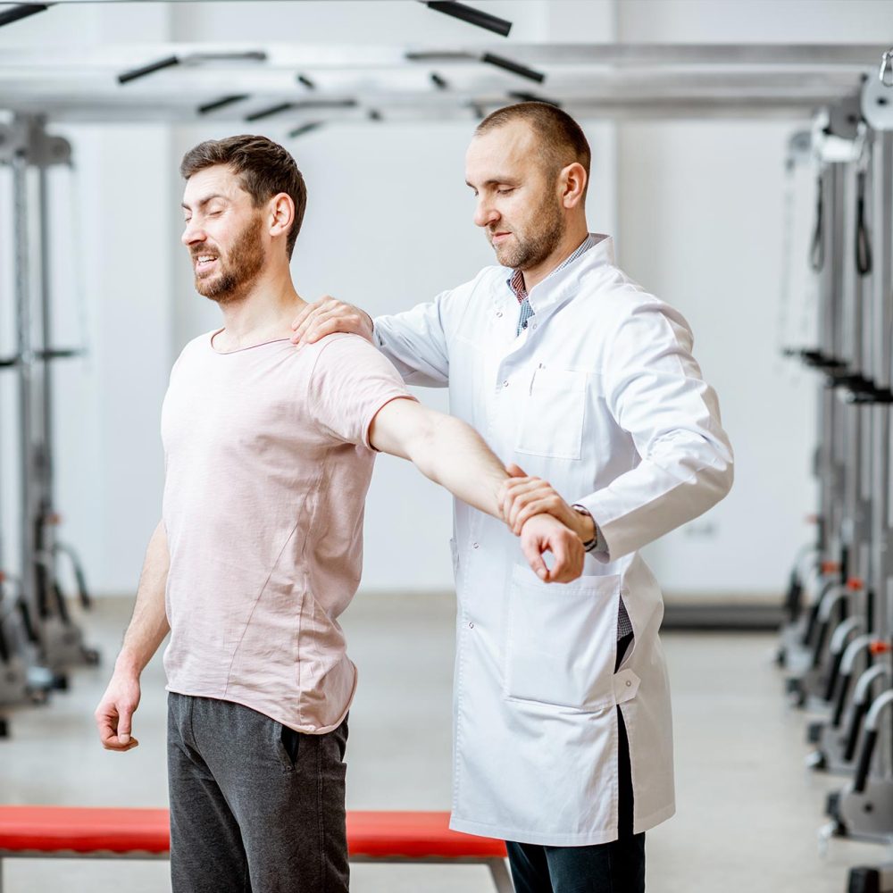 physiotherapist-doing-manual-treatment-to-a-man-2023-11-27-05-23-26-utc.jpg